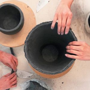 hands making objects from clay